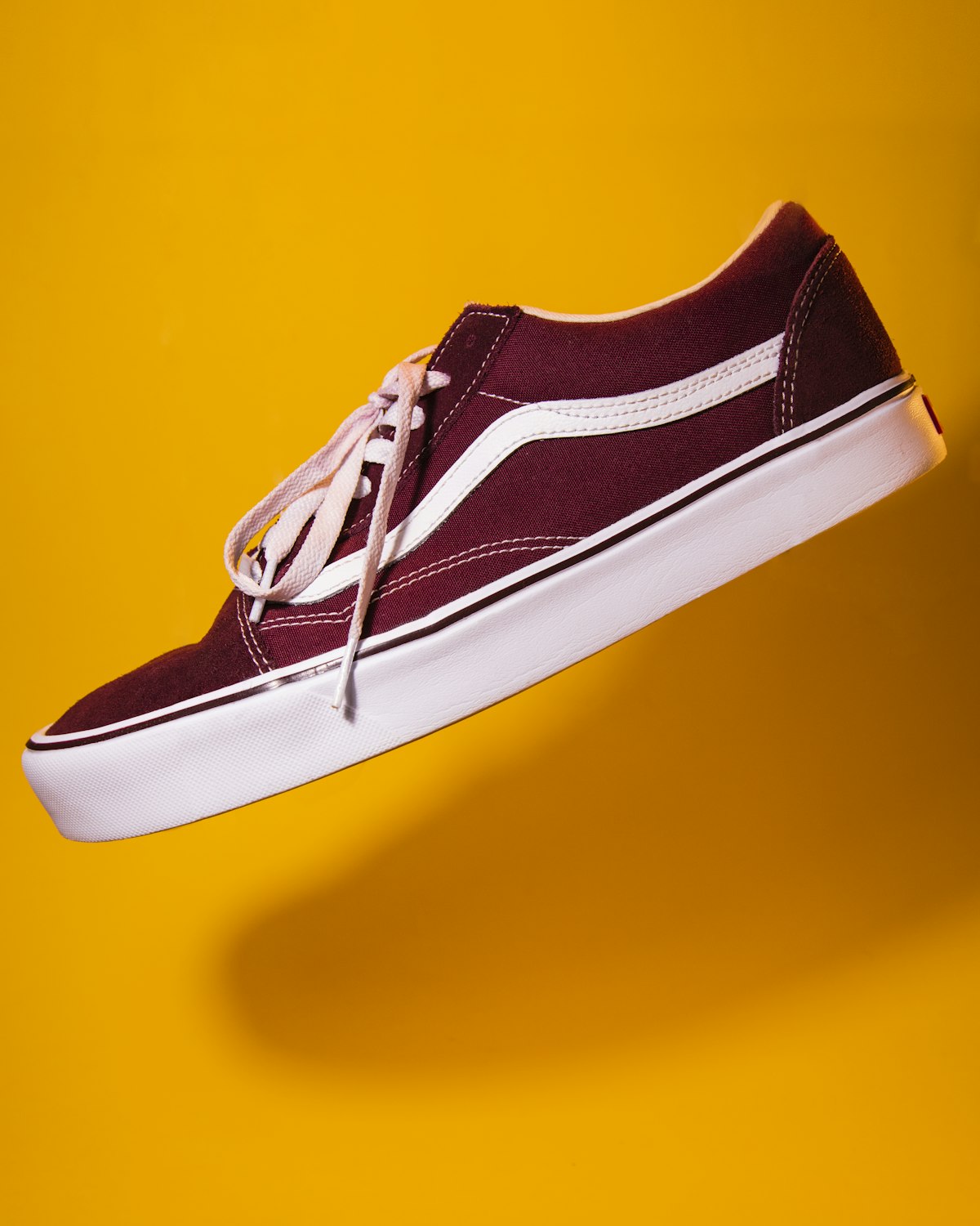 Maroon canvas low-top plimsoll shoe