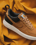 Brown suede sneaker on a yellow background