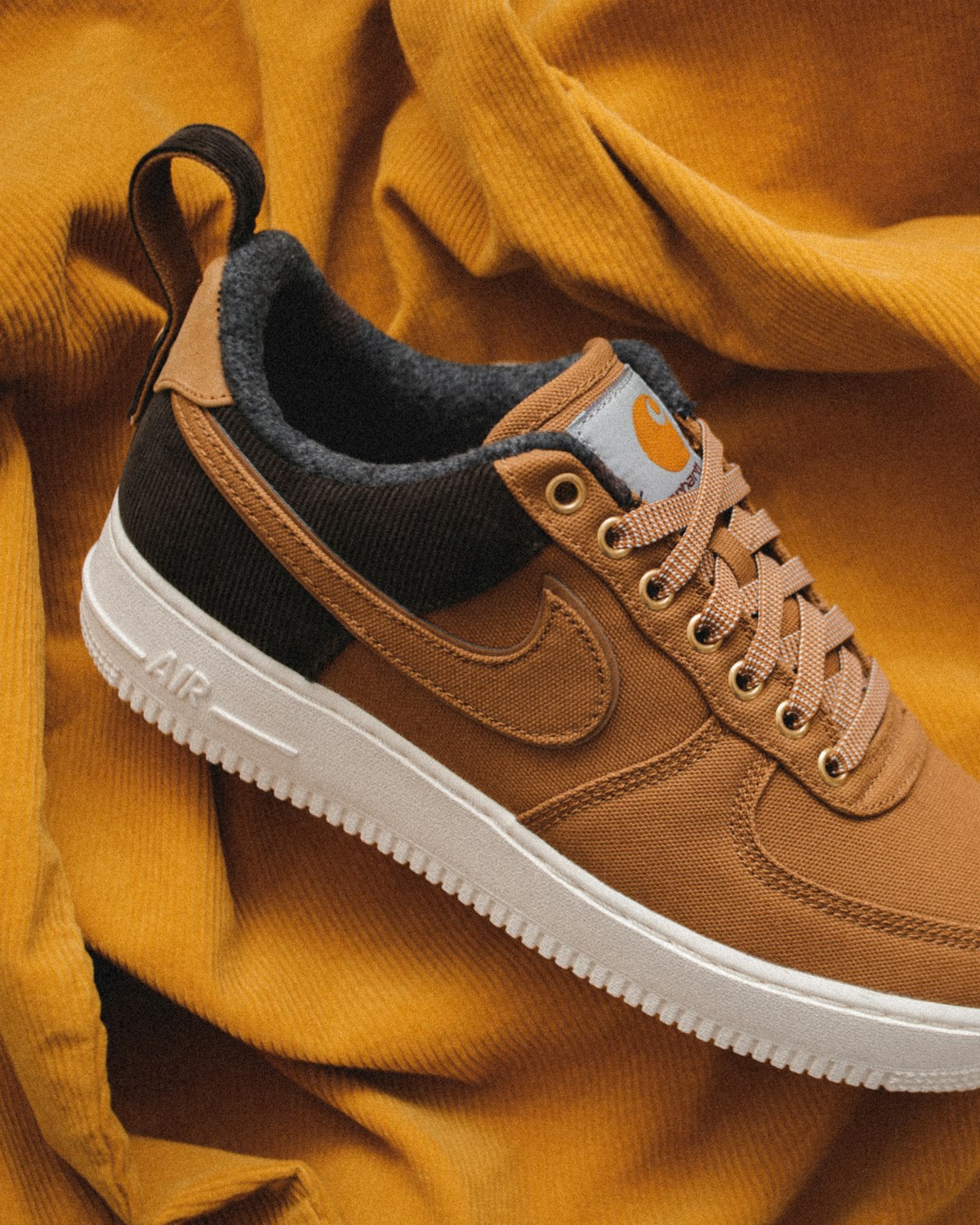 Brown suede sneaker on a yellow background