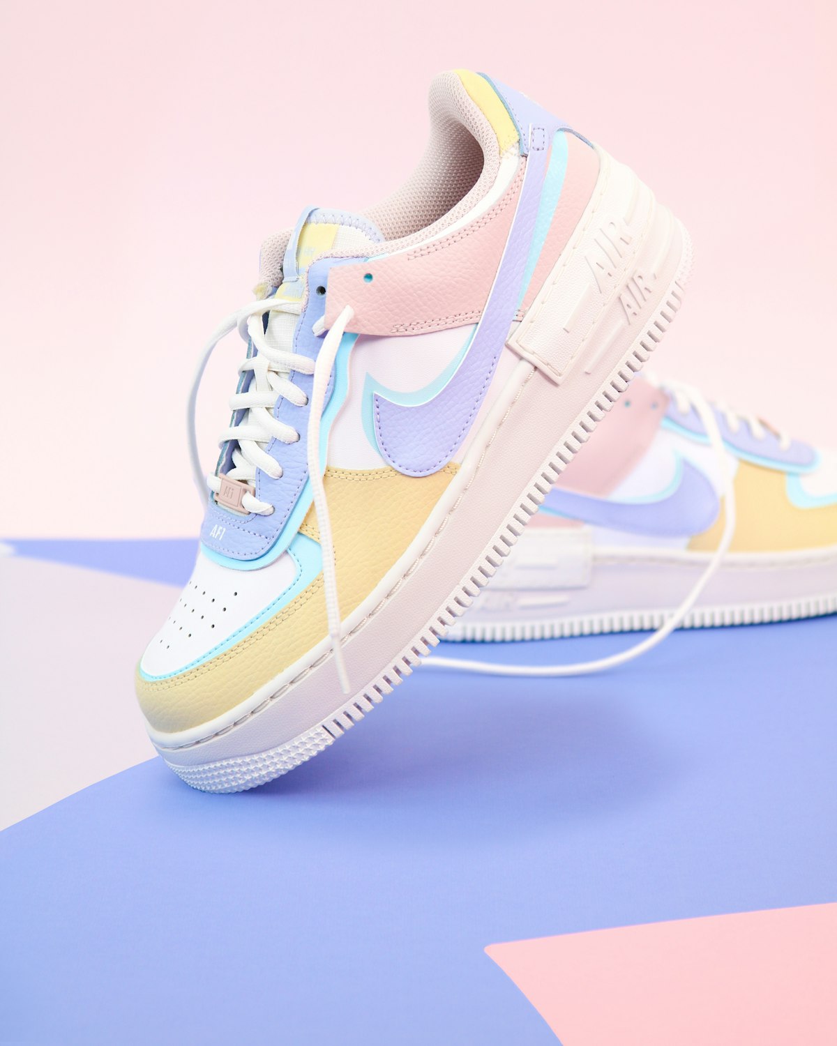 White and blue Nike Air Force 1 mid-top sneaker